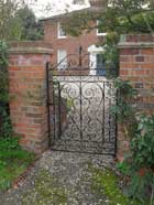 hand scrolled/clipped entrance gate