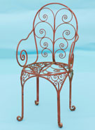 very pretty / fancy chair with lots of hand forged scrolls