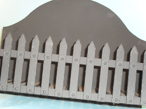 Hand forged fire grate with castle effect front.