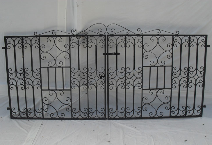 Pair of driveway gates which have been heavily decorated with hand forged scrolls