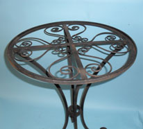 Small round table with scrolled top and feet